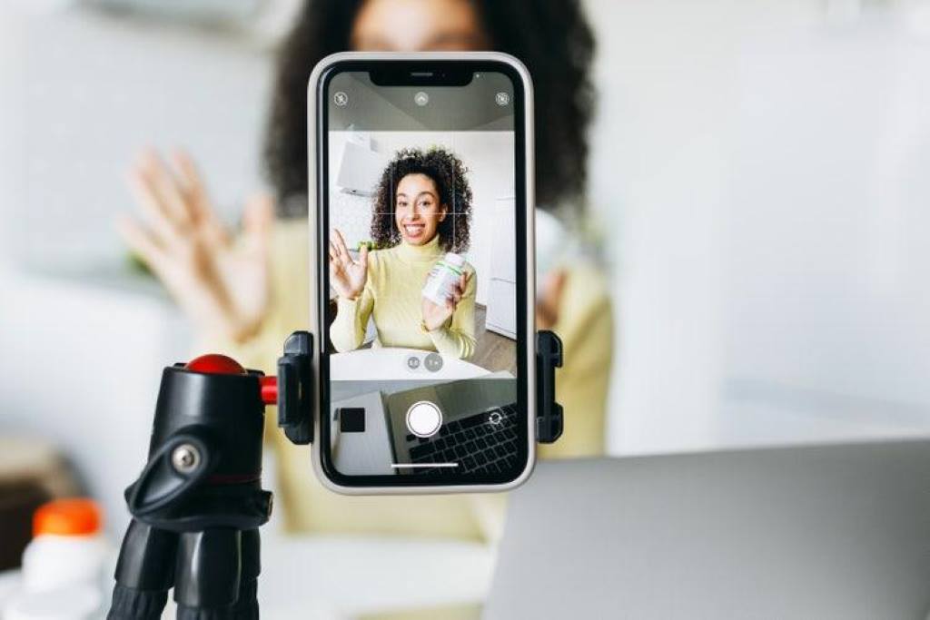 Smartphone displaying Instagram Reel upload process with vertical video settings and cover image options